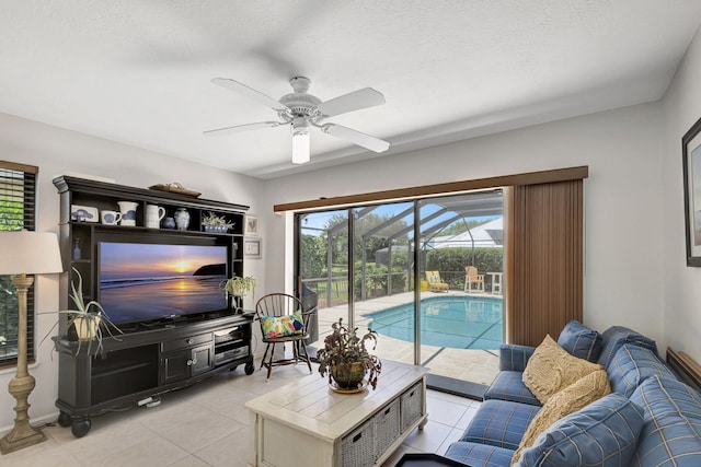 living room with ceiling fan and light tile patterned flooring