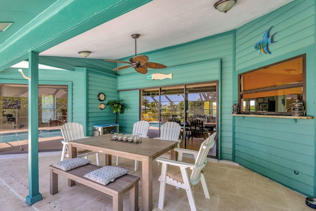 sunroom / solarium featuring ceiling fan and vaulted ceiling