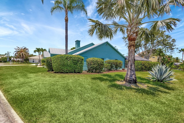 view of side of property with a yard