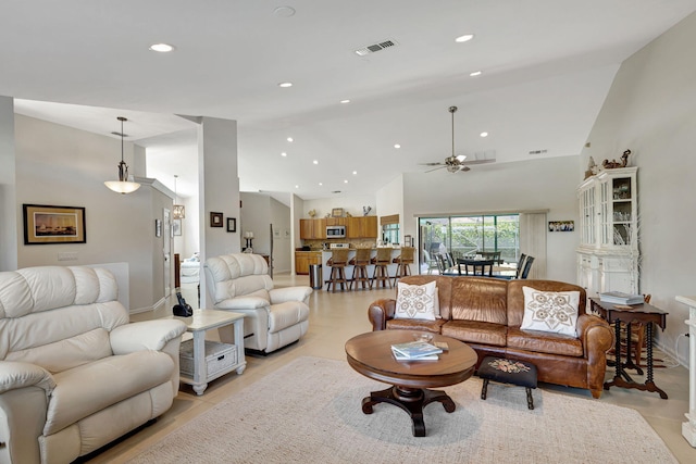 living room featuring high vaulted ceiling and ceiling fan