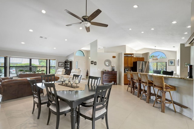 dining space featuring ceiling fan and lofted ceiling