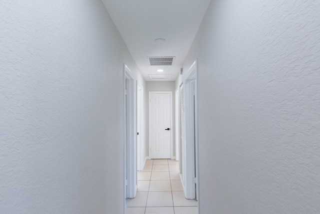 hallway with light tile patterned floors