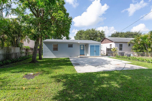 back of property featuring a patio and a lawn