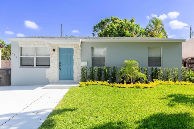 ranch-style home with a front lawn