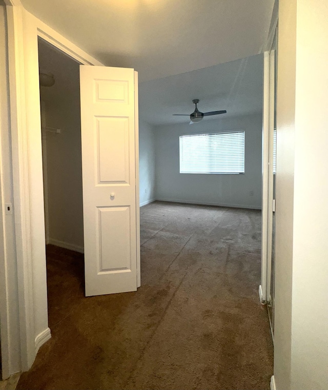 hallway with dark colored carpet