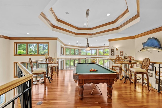 playroom with a tray ceiling, light hardwood / wood-style flooring, billiards, and ornamental molding