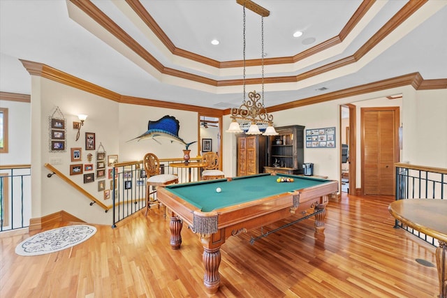 rec room with a raised ceiling, crown molding, wood-type flooring, and pool table