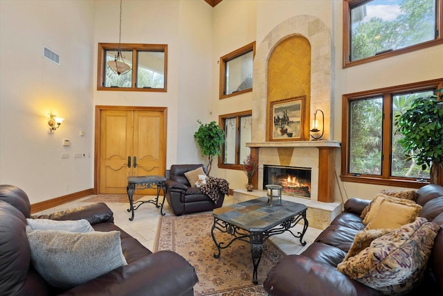 living room with a large fireplace and a towering ceiling