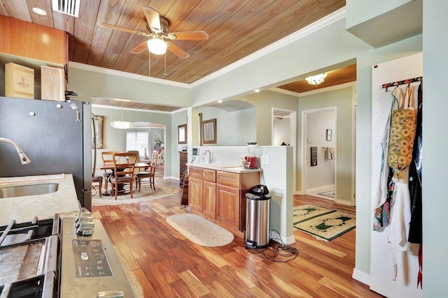 kitchen featuring wood ceiling, sink, light hardwood / wood-style floors, and ceiling fan with notable chandelier