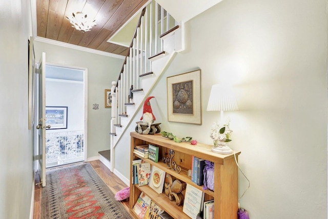 interior space featuring crown molding, wooden ceiling, and hardwood / wood-style flooring