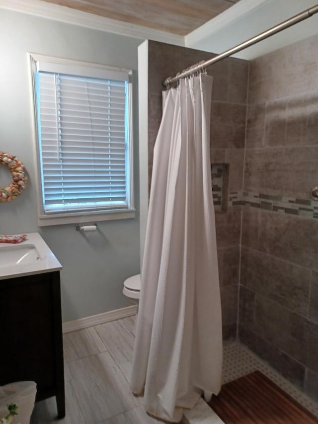 bathroom with a shower with shower curtain, vanity, toilet, and crown molding