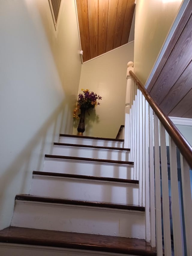 stairs featuring wooden ceiling