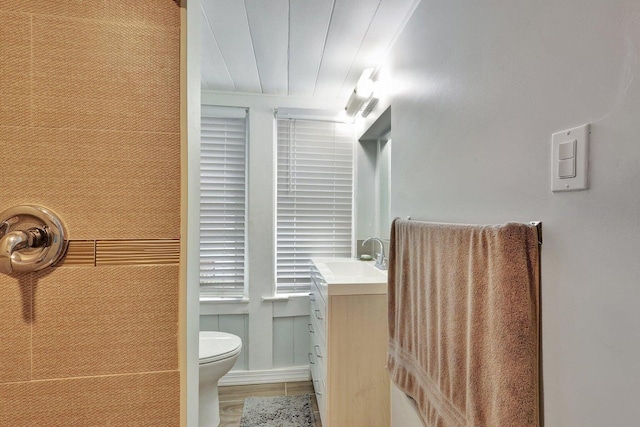 bathroom featuring hardwood / wood-style floors, vanity, and toilet