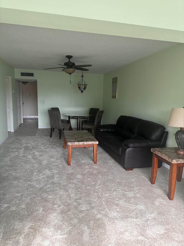 carpeted living room with ceiling fan