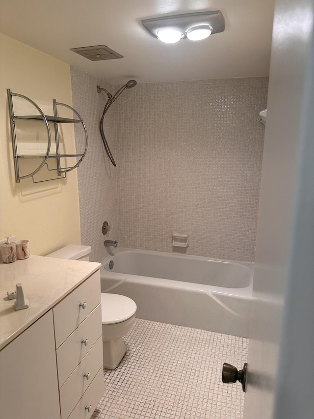 full bathroom with toilet, tiled shower / bath combo, tile patterned floors, and vanity