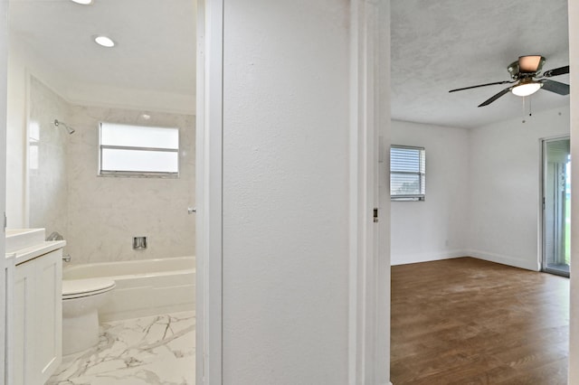 full bathroom with a wealth of natural light, toilet, vanity, and hardwood / wood-style flooring