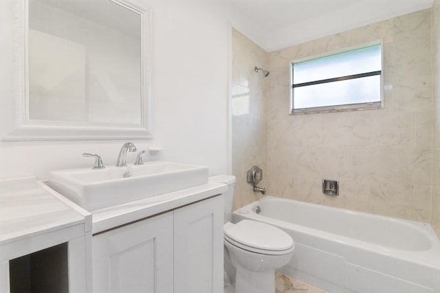 full bathroom featuring toilet, vanity, and tiled shower / bath combo