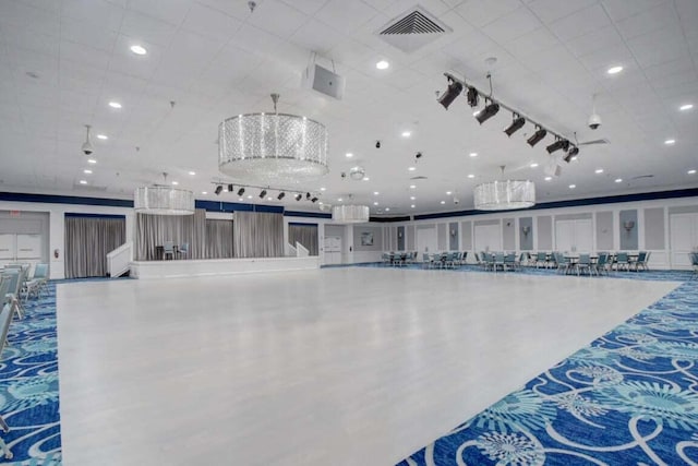 miscellaneous room with ceiling fan with notable chandelier