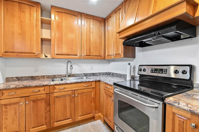 kitchen featuring stainless steel electric range oven, sink, premium range hood, stone countertops, and light tile patterned floors