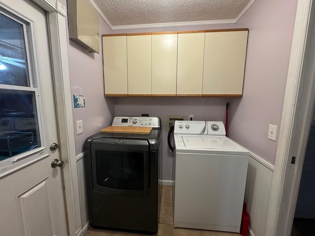 laundry area featuring separate washer and dryer, a textured ceiling, ornamental molding, cabinets, and washer hookup