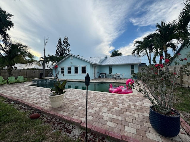 back of house featuring a patio area and a fenced in pool