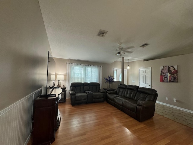 living room featuring a textured ceiling, ceiling fan, and hardwood / wood-style floors