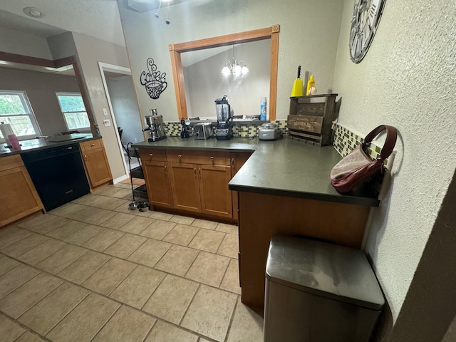 kitchen with a notable chandelier, dishwasher, kitchen peninsula, and light tile flooring