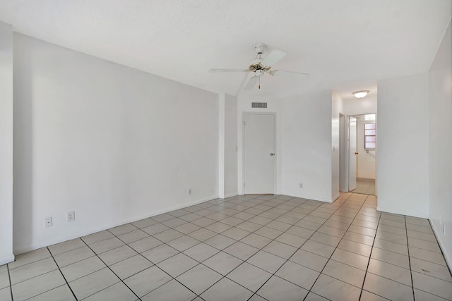 empty room featuring light tile patterned floors and ceiling fan