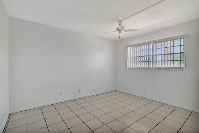 tiled spare room with ceiling fan and a textured ceiling