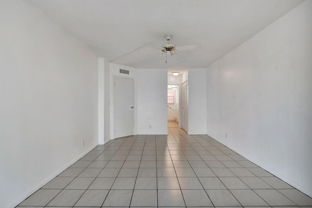 tiled empty room with ceiling fan