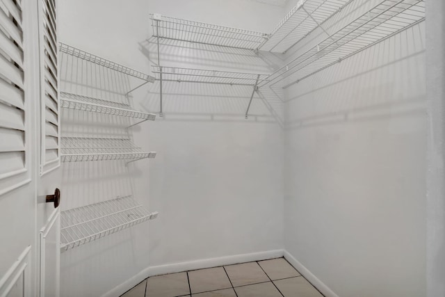 walk in closet featuring light tile patterned floors