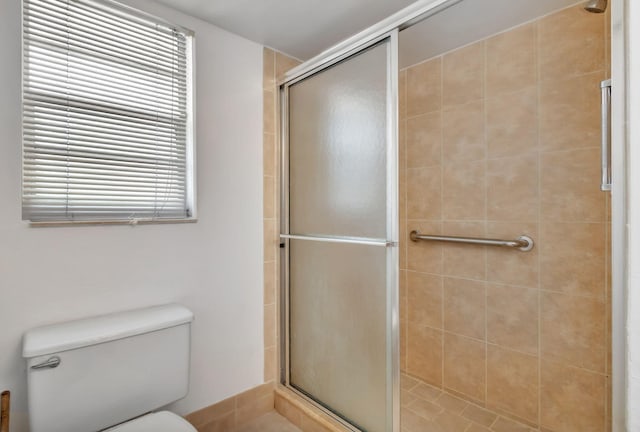 bathroom with an enclosed shower and toilet