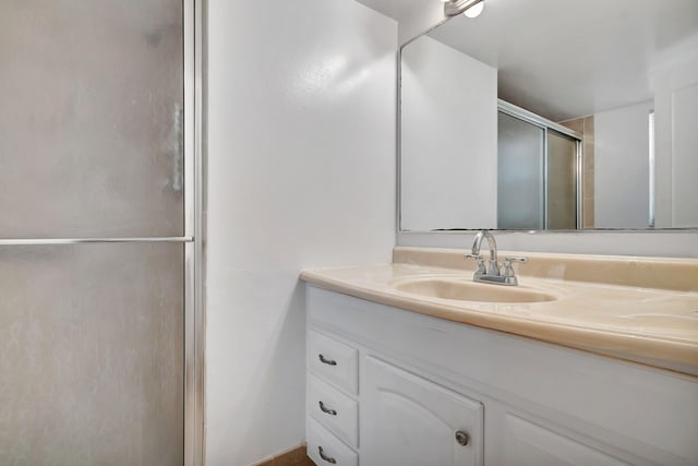 bathroom featuring vanity and an enclosed shower