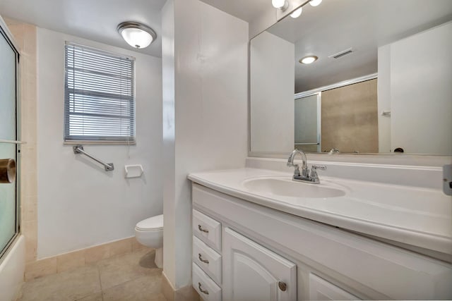 full bathroom with tile patterned floors, shower / bath combination with glass door, vanity, and toilet