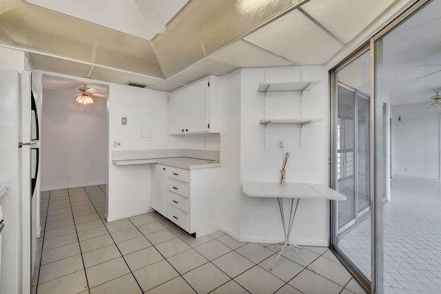 kitchen featuring white cabinets, light tile patterned floors, white fridge, and ceiling fan