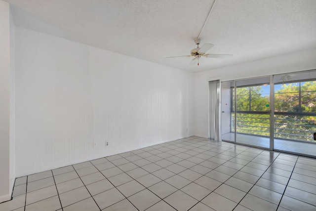 tiled spare room featuring ceiling fan and a textured ceiling