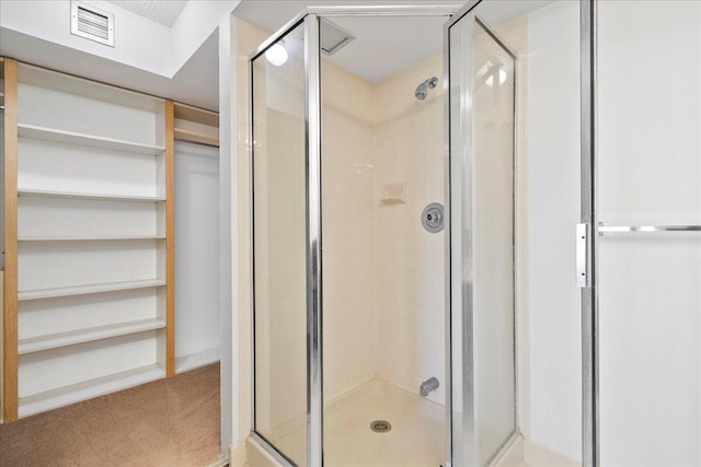 full bath featuring a shower stall and visible vents