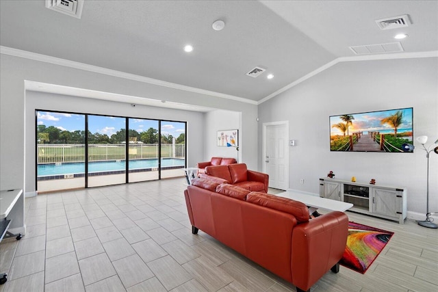 living area featuring ornamental molding, visible vents, and vaulted ceiling