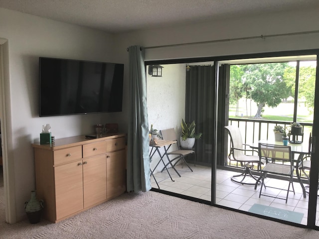 living room featuring light colored carpet and a textured ceiling