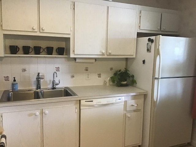 kitchen featuring tasteful backsplash, sink, and white appliances