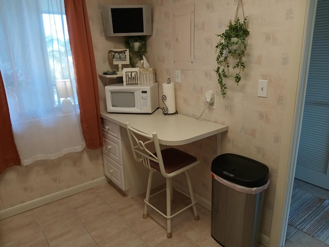 kitchen with light tile patterned floors and electric panel