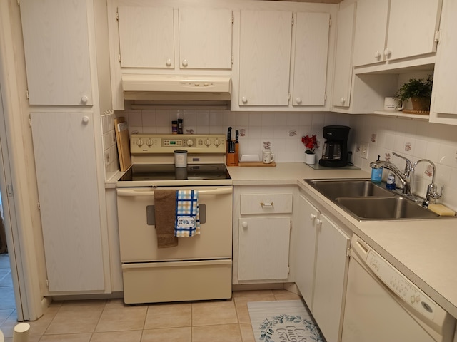 kitchen featuring white cabinetry, sink, backsplash, white appliances, and light tile patterned flooring