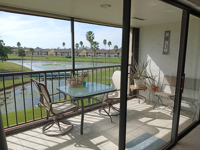 unfurnished sunroom featuring a water view