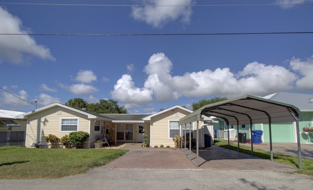 view of front of property with a front yard and a carport