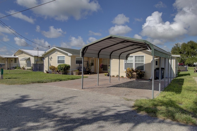 view of parking / parking lot featuring a carport and a yard