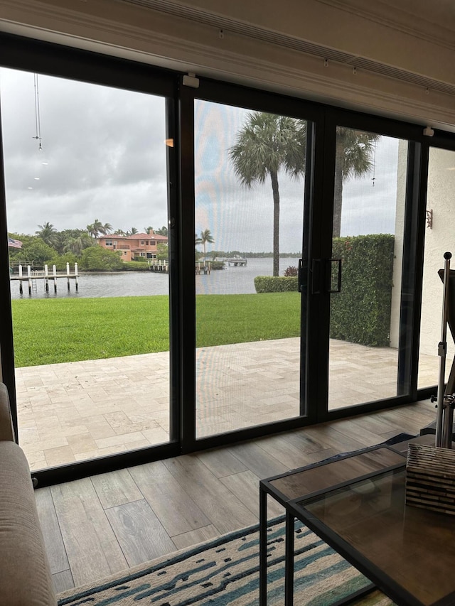 entryway featuring a water view and hardwood / wood-style flooring