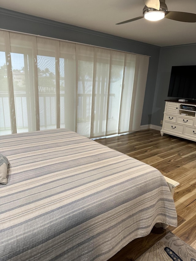 bedroom with ceiling fan and dark wood-type flooring