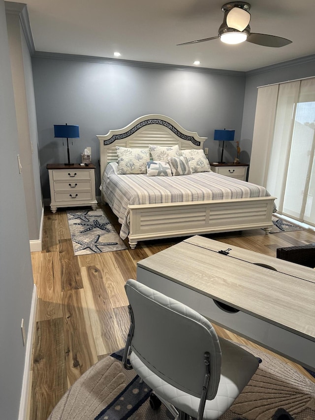 bedroom with ceiling fan, crown molding, and hardwood / wood-style flooring