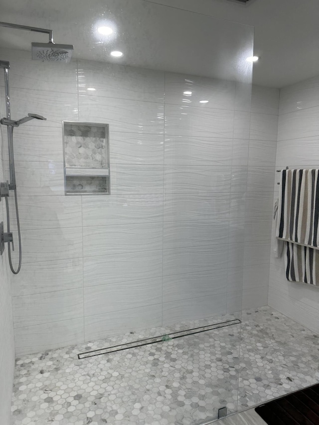 bathroom with tiled shower