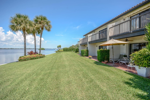 view of yard with a balcony and a water view